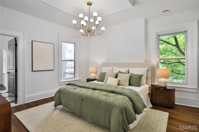 6504 Michigan Ave, Saint Louis, MO 63111 - bedroom with a chandelier, wood finished floors, and baseboards