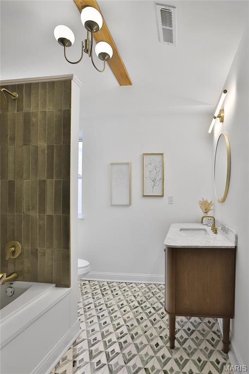 6504 Michigan Ave, Saint Louis, MO 63111 - full bath featuring toilet, vanity, tile patterned floors, baseboards, and shower / bath combination