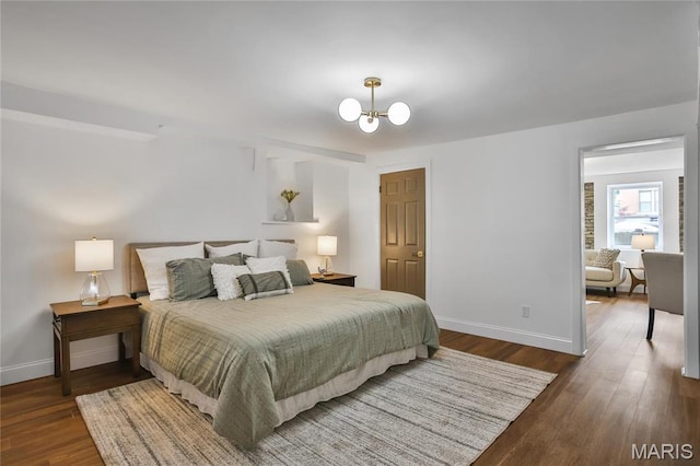 6504 Michigan Ave, Saint Louis, MO 63111 - bedroom featuring baseboards, wood finished floors, and a chandelier