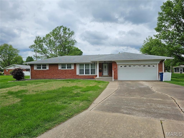 1117 Meadow Ln, Sparta, IL 62286 - ranch-style house with concrete driveway, brick siding, an attached garage, and a front yard