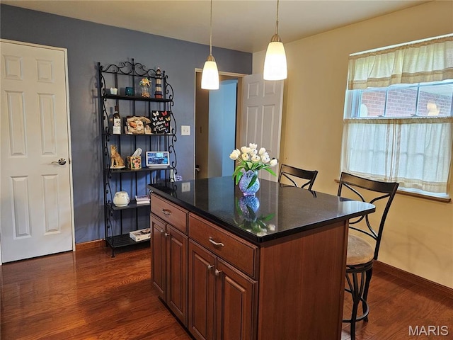 1117 Meadow Ln, Sparta, IL 62286 - kitchen with dark wood-style floors, a kitchen breakfast bar, baseboards, and a center island