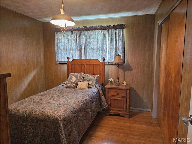 1117 Meadow Ln, Sparta, IL 62286 - bedroom featuring wood finished floors, wood walls, and a closet