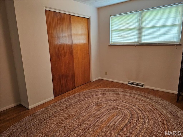 1117 Meadow Ln, Sparta, IL 62286 - unfurnished bedroom featuring wood finished floors, a closet, and baseboards