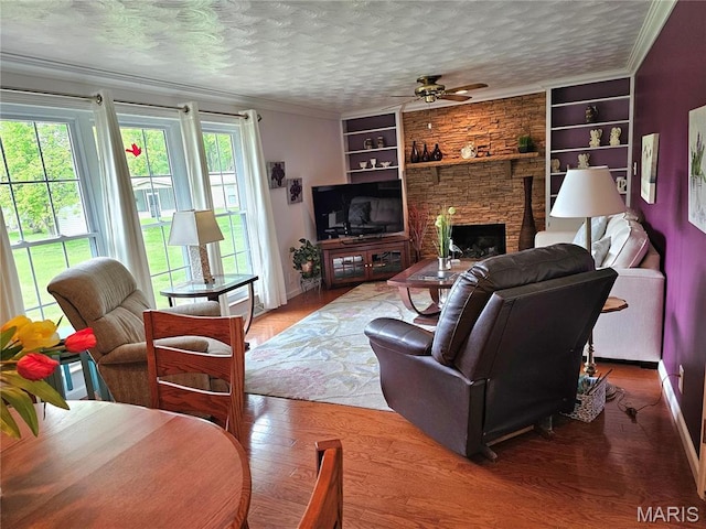 1117 Meadow Ln, Sparta, IL 62286 - living area featuring ornamental molding, ceiling fan, baseboards, a fireplace, and built in shelves
