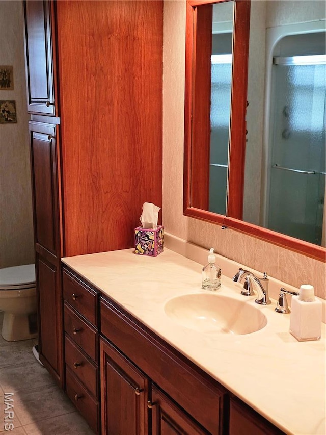 1117 Meadow Ln, Sparta, IL 62286 - bathroom with toilet, vanity, tile patterned flooring, and an enclosed shower