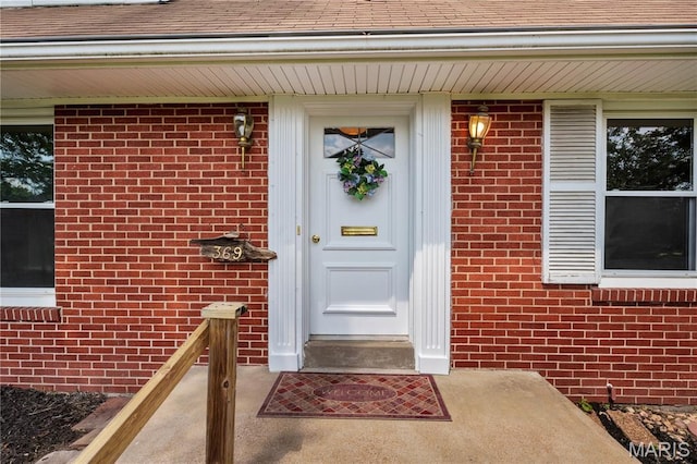 369 Halcyon Dr, Saint Louis, MO 63122 - doorway to property featuring brick siding and a shingled roof