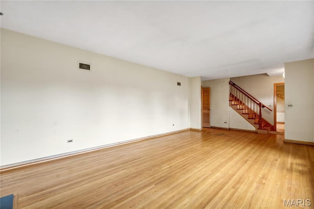 369 Halcyon Dr, Saint Louis, MO 63122 - unfurnished living room with light wood-style floors and stairway