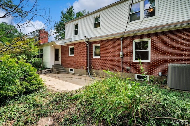 369 Halcyon Dr, Saint Louis, MO 63122 - back of house featuring entry steps, brick siding, and a patio area
