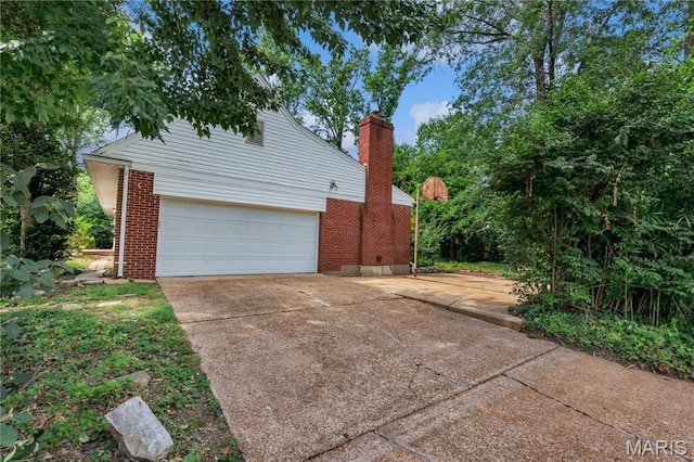 369 Halcyon Dr, Saint Louis, MO 63122 - view of home's exterior with brick siding, driveway, and a chimney