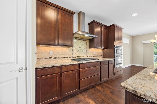 1109 Spruce Forest Dr, Lake St Louis, MO 63367 - kitchen featuring wall chimney exhaust hood, stainless steel appliances, dark wood-type flooring, decorative backsplash, and light stone counters