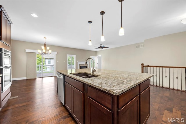 1109 Spruce Forest Dr, Lake St Louis, MO 63367 - kitchen featuring a sink, a chandelier, a fireplace, appliances with stainless steel finishes, and dark wood finished floors