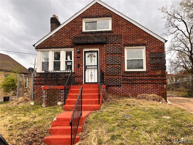 6604 Donald St, Saint Louis, MO 63121 - bungalow-style home with brick siding and a chimney