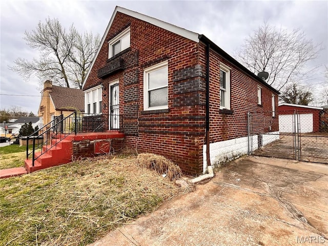 6604 Donald St, Saint Louis, MO 63121 - view of side of property featuring brick siding and a detached garage
