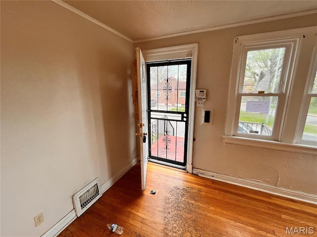 6604 Donald St, Saint Louis, MO 63121 - entrance foyer featuring plenty of natural light, wood finished floors, and crown molding