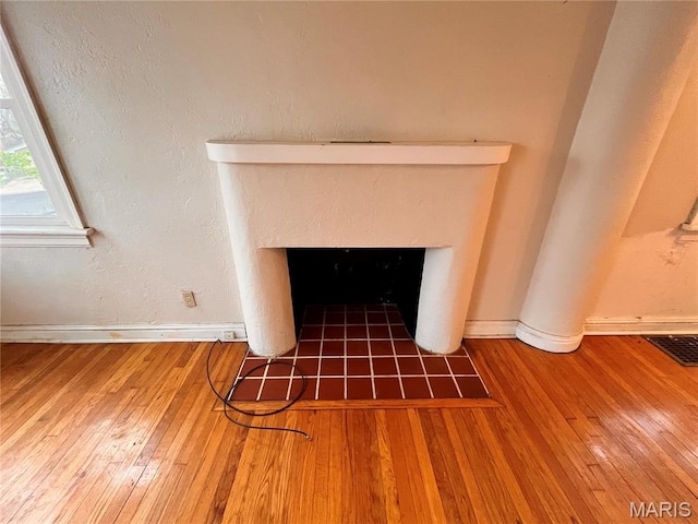 6604 Donald St, Saint Louis, MO 63121 - detailed view of wood finished floors and a fireplace