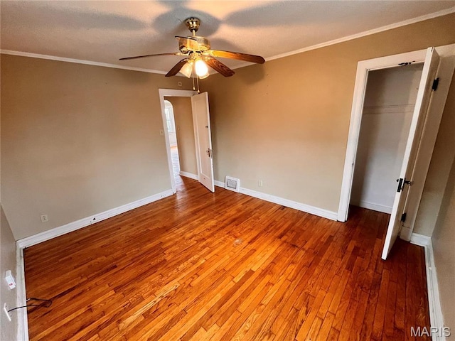 6604 Donald St, Saint Louis, MO 63121 - unfurnished bedroom featuring hardwood / wood-style flooring, ornamental molding, ceiling fan, and a closet