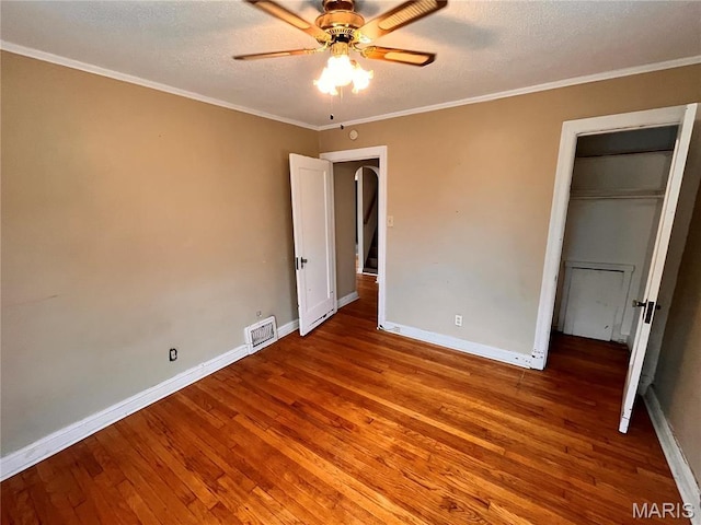 6604 Donald St, Saint Louis, MO 63121 - unfurnished bedroom with wood finished floors, crown molding, a textured ceiling, and ceiling fan
