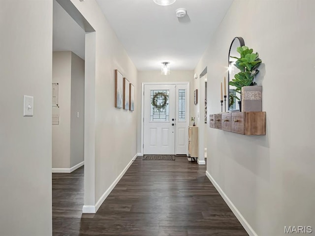 entryway featuring dark wood-type flooring and baseboards