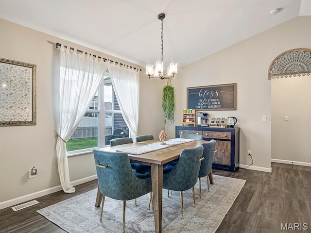 dining area featuring a chandelier, lofted ceiling, baseboards, and dark wood finished floors