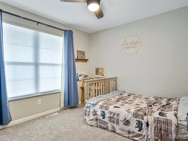 bedroom featuring multiple windows, carpet, baseboards, and ceiling fan