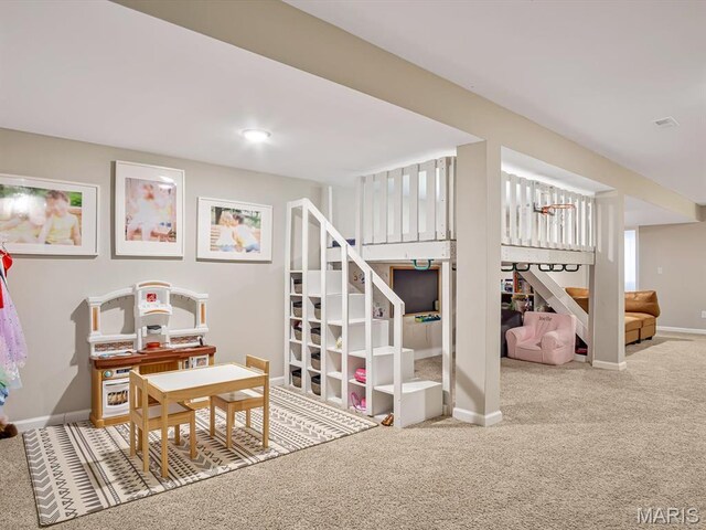 playroom featuring carpet flooring and baseboards