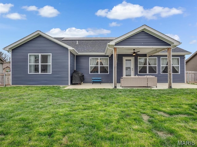 rear view of property with a patio, ceiling fan, an outdoor hangout area, and a shingled roof