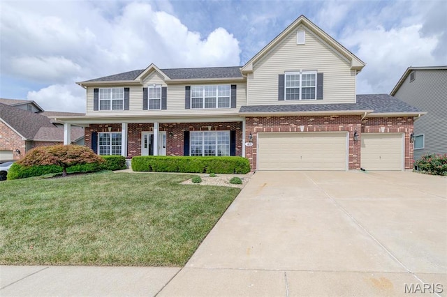 41 Deer Creek Dr, Ofallon, MO 63366 - view of front of house with a front yard, driveway, brick siding, an attached garage, and a shingled roof
