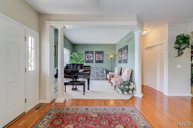 41 Deer Creek Dr, Ofallon, MO 63366 - entryway with ornate columns, wood finished floors, and baseboards
