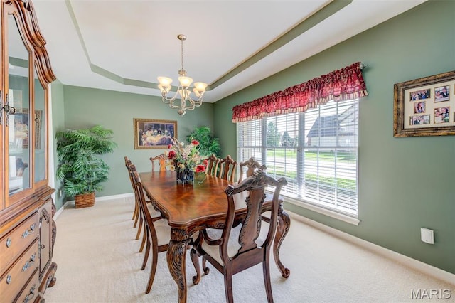 41 Deer Creek Dr, Ofallon, MO 63366 - dining space with a chandelier, light colored carpet, a raised ceiling, and baseboards