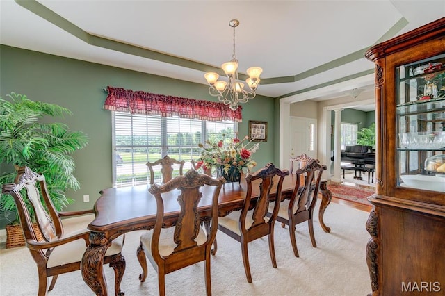 41 Deer Creek Dr, Ofallon, MO 63366 - dining space featuring a chandelier, light colored carpet, and baseboards