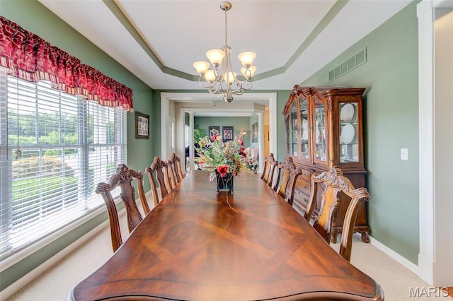 41 Deer Creek Dr, Ofallon, MO 63366 - dining area with a chandelier, healthy amount of natural light, carpet flooring, and a tray ceiling