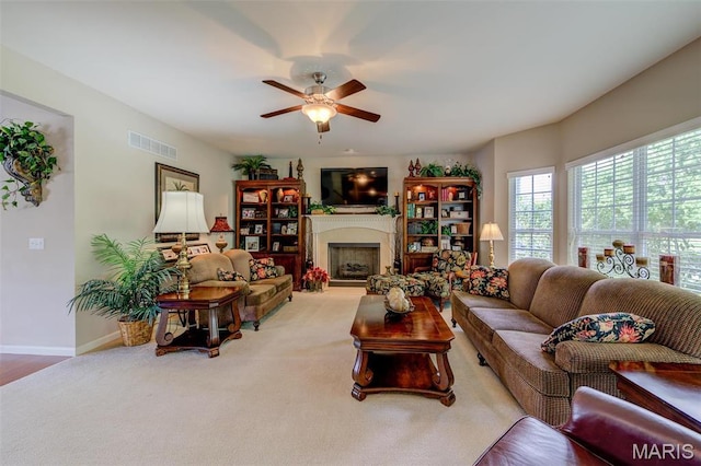 41 Deer Creek Dr, Ofallon, MO 63366 - carpeted living area featuring a ceiling fan, a fireplace, and baseboards