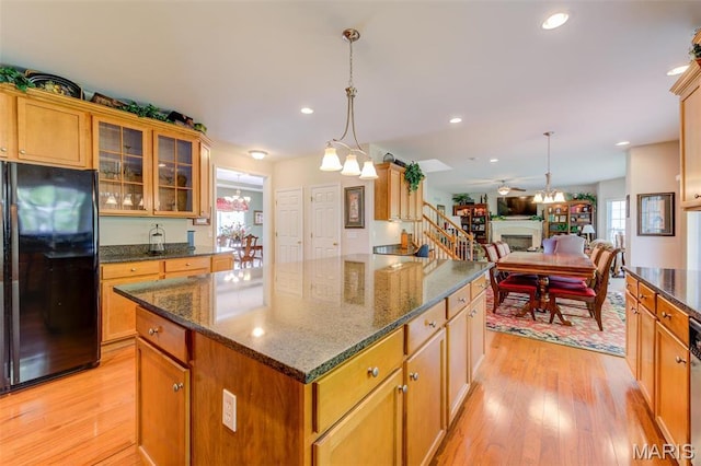 41 Deer Creek Dr, Ofallon, MO 63366 - kitchen featuring freestanding refrigerator, light wood finished floors, glass insert cabinets, a center island, and recessed lighting