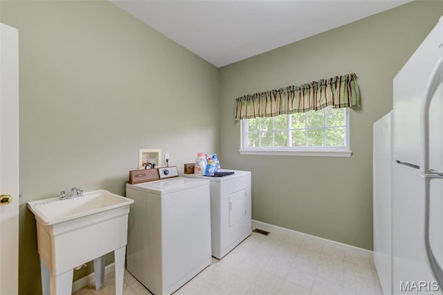 41 Deer Creek Dr, Ofallon, MO 63366 - clothes washing area with washing machine and dryer and baseboards