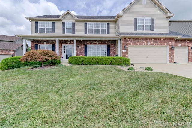 41 Deer Creek Dr, Ofallon, MO 63366 - view of front facade featuring concrete driveway, brick siding, and a front yard