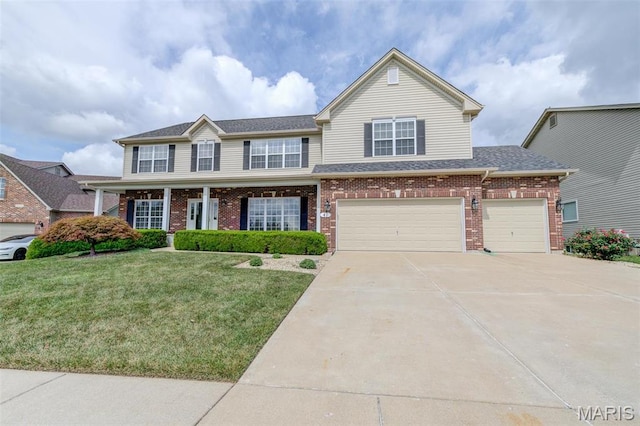 41 Deer Creek Dr, Ofallon, MO 63366 - view of front of home featuring a front lawn, driveway, brick siding, an attached garage, and a shingled roof