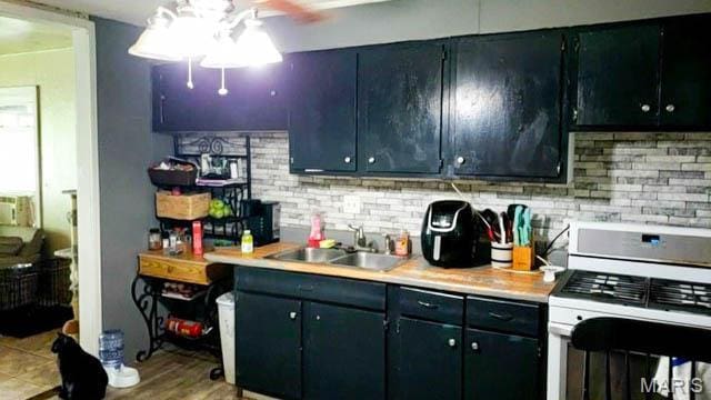 1732 Ferguson Ave, Granite City, IL 62040 - kitchen with gas range gas stove, ceiling fan, light countertops, and a sink