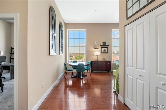 hallway featuring hardwood / wood-style floors and baseboards
