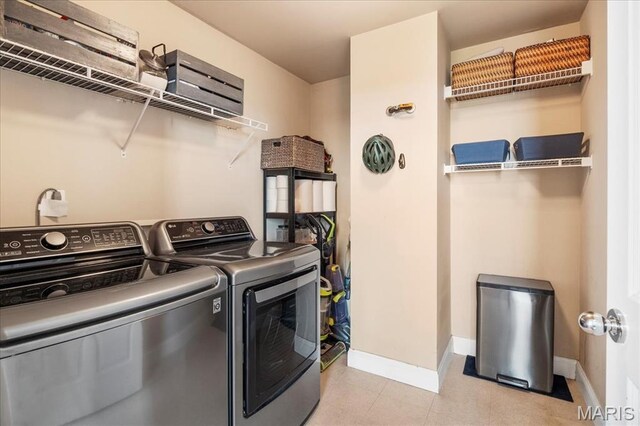 laundry room featuring washer and dryer and baseboards