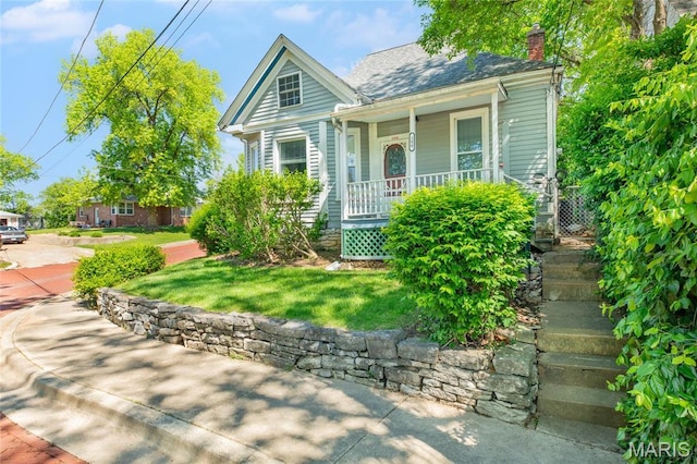 view of front of property with covered porch and a chimney