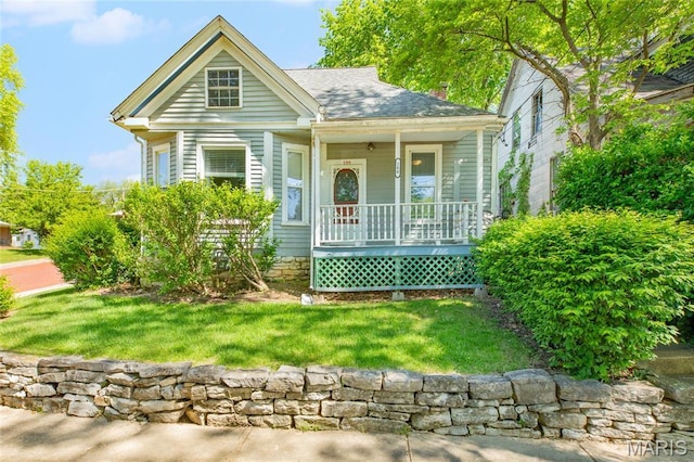 view of front of house with covered porch and a chimney