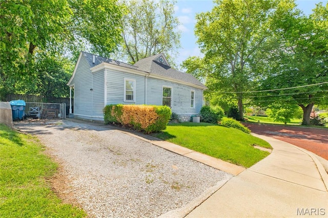 view of side of property featuring gravel driveway