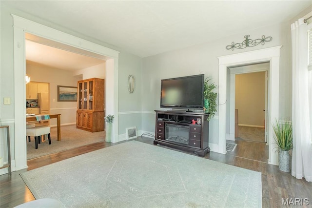 living room featuring wood finished floors and baseboards
