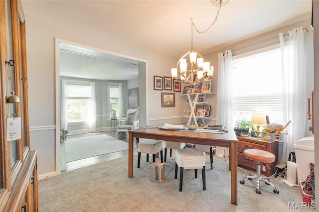 carpeted dining space with a desk and a chandelier