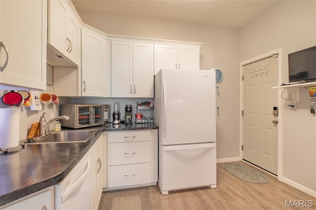 kitchen with white appliances, a sink, white cabinetry, and dark countertops