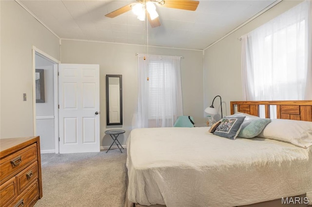 bedroom featuring crown molding, light carpet, and ceiling fan