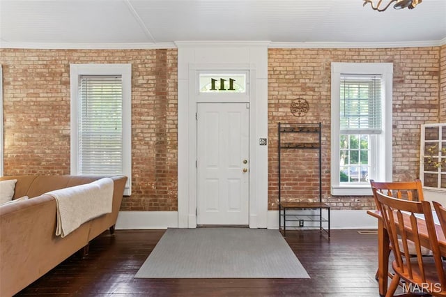 111 Portland Ave, Belleville, IL 62220 - foyer entrance featuring plenty of natural light, brick wall, hardwood / wood-style floors, crown molding, and baseboards