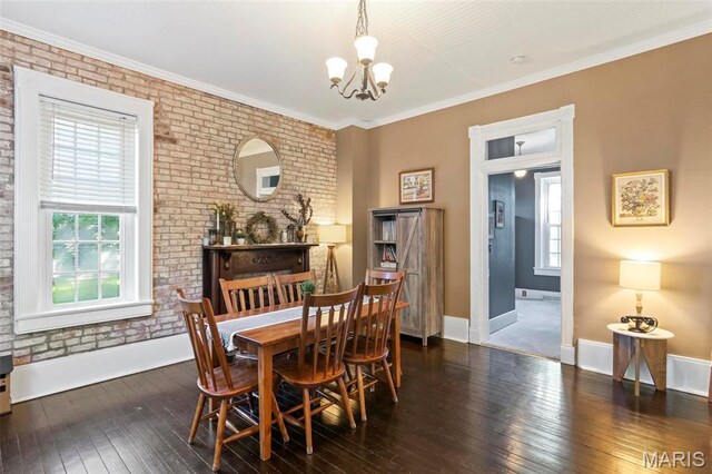 111 Portland Ave, Belleville, IL 62220 - dining area with a chandelier, hardwood / wood-style floors, plenty of natural light, brick wall, and baseboards