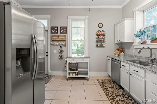 111 Portland Ave, Belleville, IL 62220 - kitchen with appliances with stainless steel finishes, a sink, baseboards, light stone countertops, and crown molding