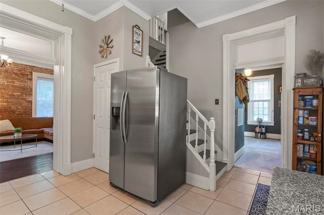 111 Portland Ave, Belleville, IL 62220 - kitchen with stainless steel refrigerator with ice dispenser, light tile patterned flooring, baseboards, crown molding, and a chandelier